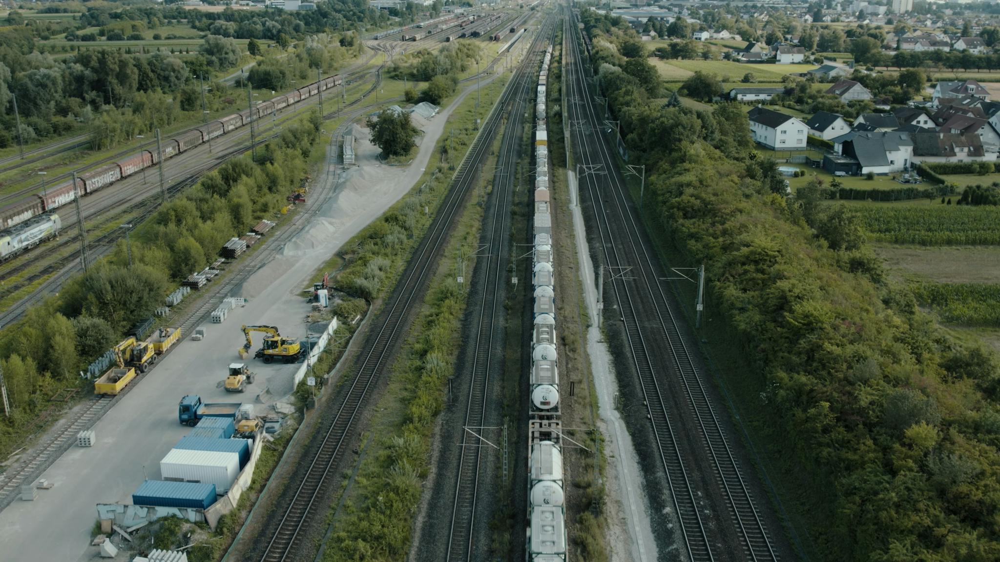 Aerial view of a freight train passing through railway tracks in Offenburg, Germany.